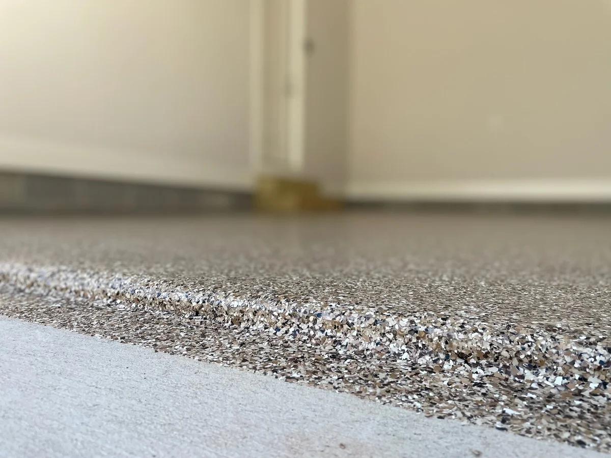 Residential garage beautifully transformed with a polyaspartic floor coating by NC Garage Floors in Raleigh, NC