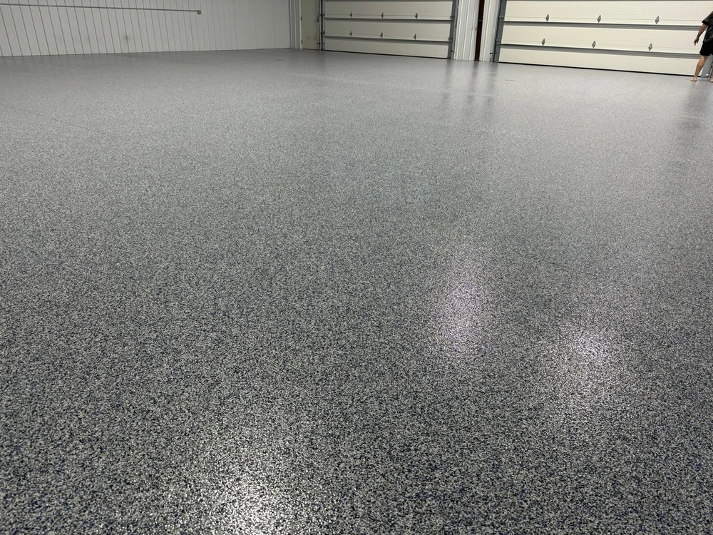 Finished gray polyaspartic flake garage floor coating in a residential garage in Raleigh, NC by NC Garage Floors