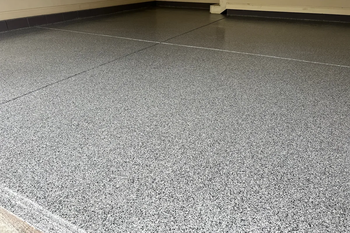 Polyaspartic flake garage floor coating installed in a Cary, NC residential garage by NC Garage Floors