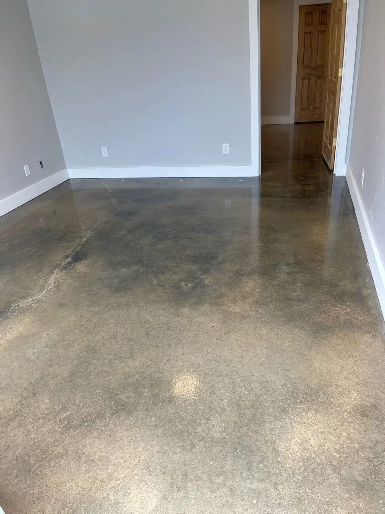 Smooth stained concrete floor finish in a residential space in Clayton, NC, applied by NC Garage Floors