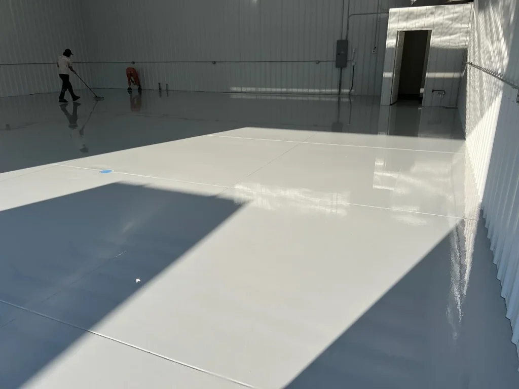 Solid white epoxy floor coating in a metal building in Garner, NC, installed by NC Garage Floors